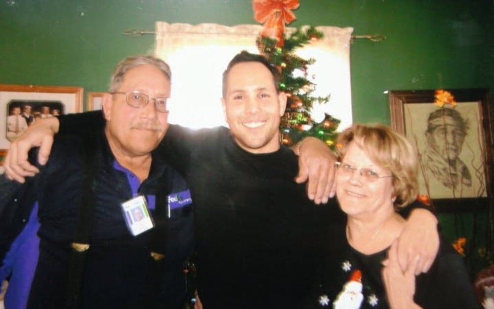 Garrett McClure with his dad, in his FedEx vest, and his mom