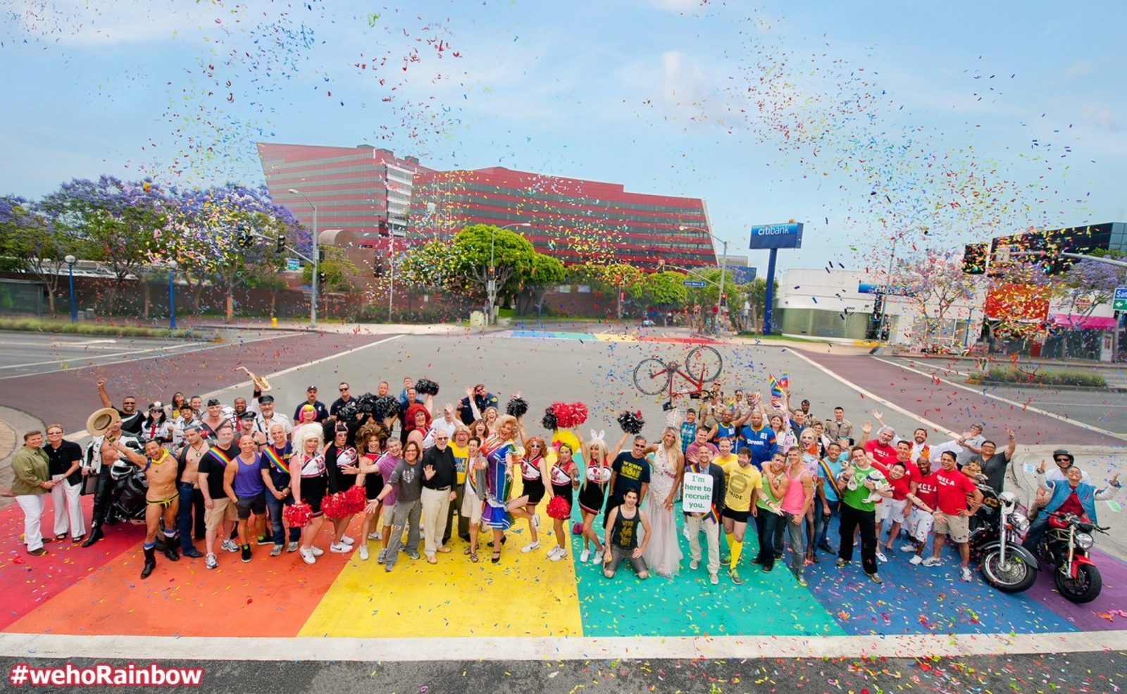 The dedication of the world's first permanent rainbow crosswalks in West Hollywood, with a large crowd and confetti