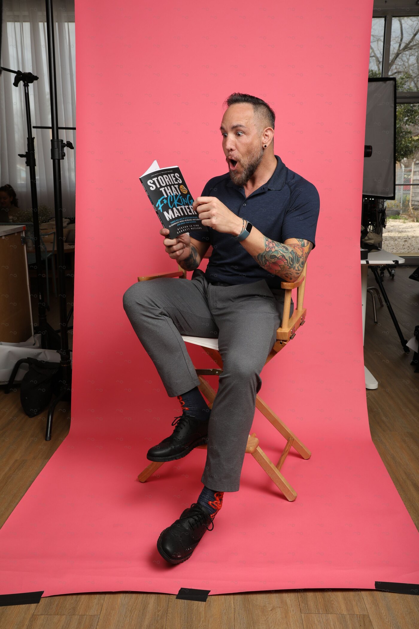 Garrett McClure holding his book Stories That F*cking Matter