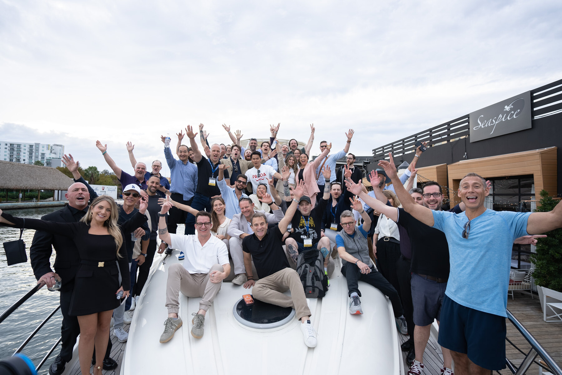 Garrett McClure with the DealCon Deal Boardroom community celebrating together on a yacht in Miami